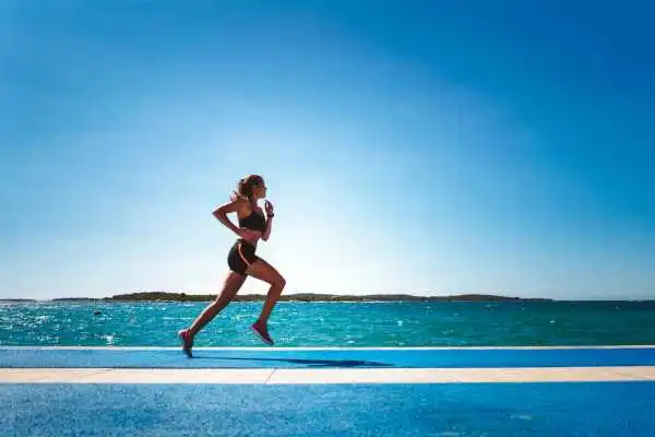 Woman running showing strong leg muscle Bristol